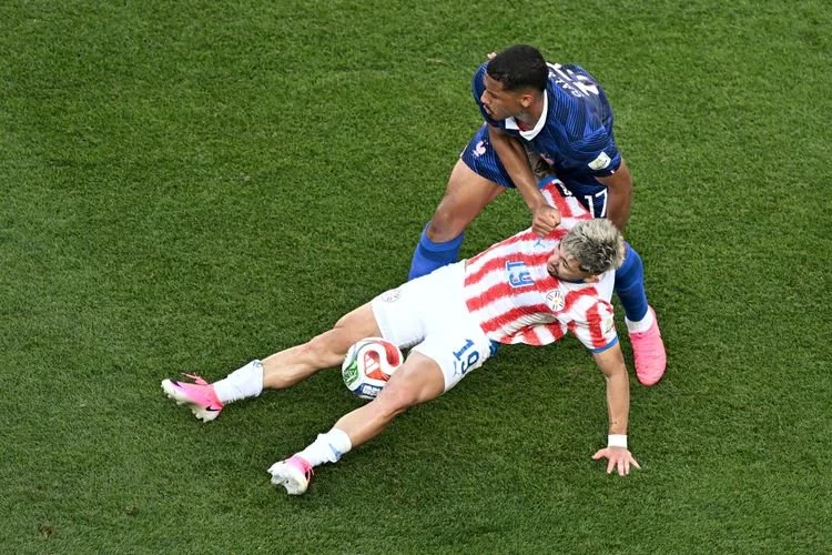 Gelandang Paraguay, Julio Enciso, dan bek Perancis William Saliba berebut bola dalam pertandingan 16 besar Piala Dunia 2026 di Stadion Philadelphia pada 4 Juli 2026.