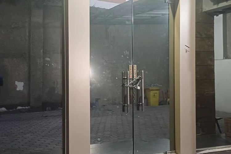 Pintu kaca ruko yang digeledah polisi di Cipete Selatan, Cilandak, Jakarta Selatan, dalam kondisi digembok, Jumat (10/7/2026)