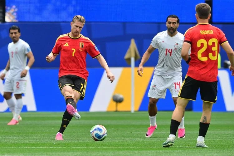 Gelandang Iran, Saman Ghoddos, dan gelandang Belgia, Kevin De Bruyne, berebut bola selama pertandingan sepak bola Grup G Piala Dunia 2026 antara Belgia dan Iran di Stadion Los Angeles di Inglewood pada 21 Juni 2026.